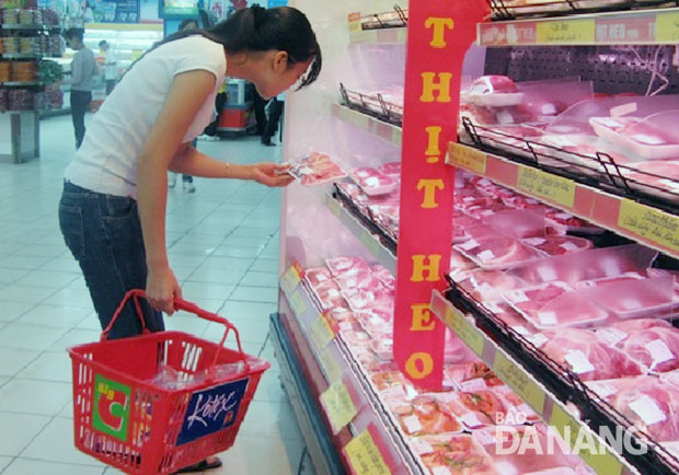  A customer choosing imported meat at a local supermarket