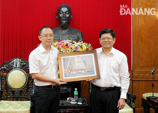 Phó Bí thư Thường trực Thành ủy Võ Công Trí tặng quà lưu niệm ông Kim Tương Quân.  Ảnh: ĐẶNG NỞ