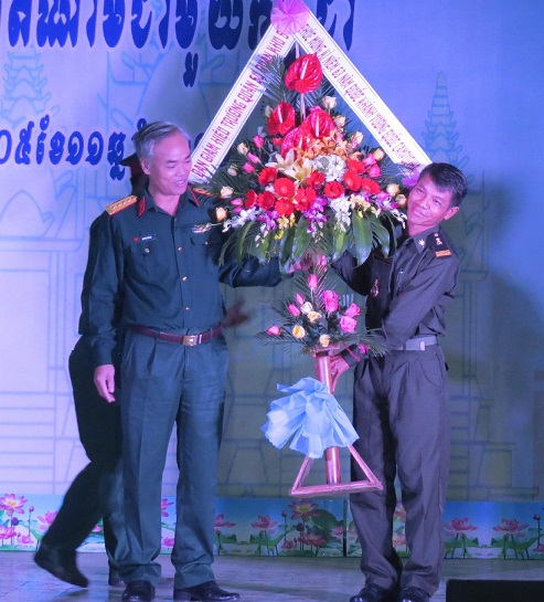 A representative from the Military School of Military Region 5 presenting flowers to an RCAF trainee 