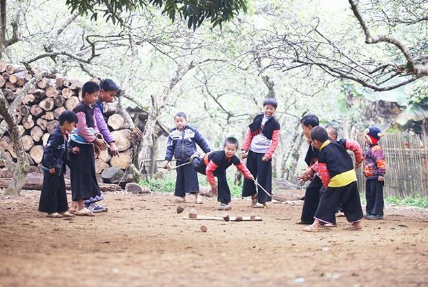 Boys play spinning top, a popular game among the H'Mong community.