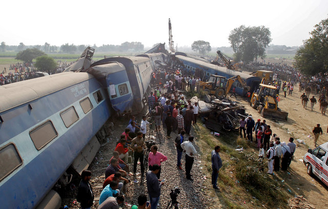 Rescue workers search for survivors at the site of a train derailment in Pukhrayan, south of Kanpur city, India November 20, 2016. Photo by Reuters/Jitendra Prakash