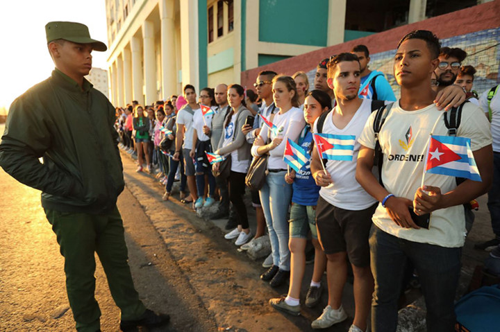 Thanh niên Cuba đợi chờ đoàn xe chở lãnh tụ Fidel Castro. Ảnh: Getty.