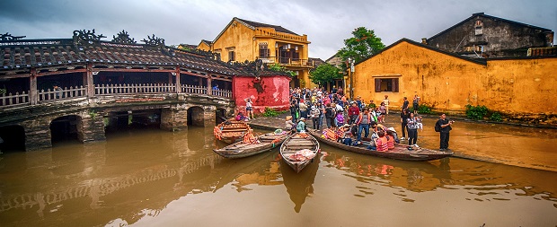  Visitors take to wooden boats near the ‘Chua Cau’(Japanese Covered Bridge), the symbol of Hoi An