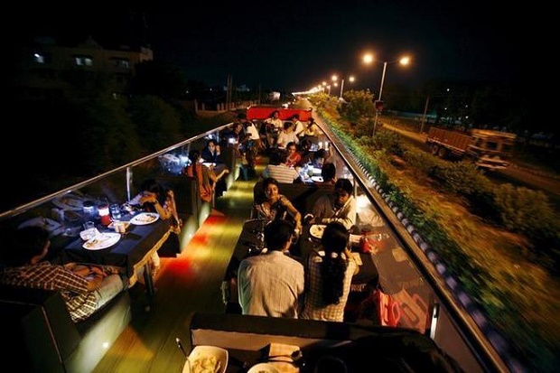 People dine on a double-decker bus which has been converted to a mobile restaurant as it travels through the streets of Ahmedabad June 23, 2010. Photo by Reuters/Amit Dave