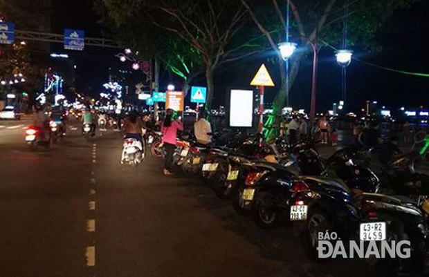 Bicycles and motorcycles parked along Bach Dang