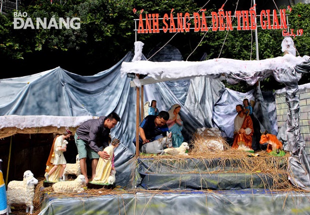 Decorating Christmas crib at the Da Nang Cathedral, known to the locals as ‘Nha Tho Con Ga’ (Rooster Cathedral)