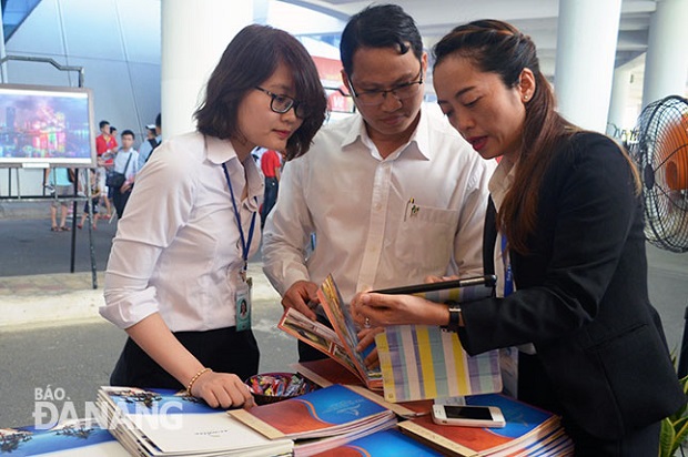 Staff from a local business introducing their products via a tablet at the 2016 Beach Leisure & MICE Travel Mart in June