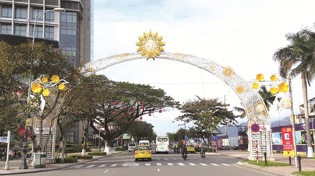 Decorations alongside a local street, including images of artificial  yellow apricot blossom