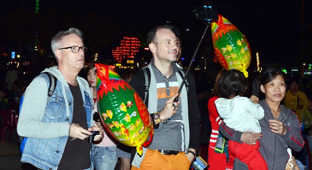  Some foreign visitors enjoying the bustling atmosphere of the Vietnamese Tet Festival