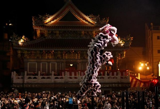 Dancers perform a lion dance in front of a temple as they celebrate the Lunar New Year in China Town, in Yokohama, south of Tokyo, Japan. (Reuters)