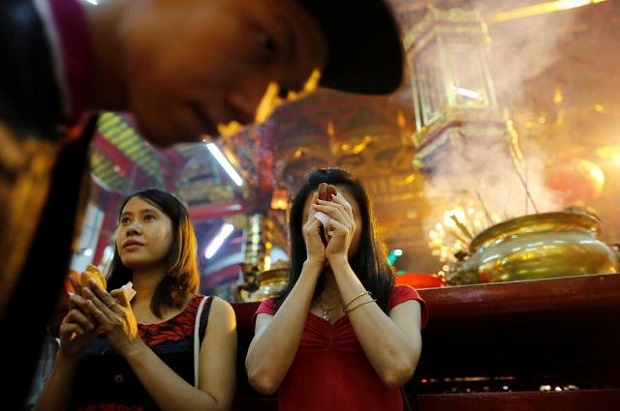 Girls pray in a temple during the Lunar New Year's festival in Chinatown, in Yangon, Myanmar. (Reuters)