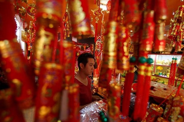 A man is seen selling goods in a decorations market during Lunar New Year eve in Phnom Penh, Cambodia. (Reuters)
