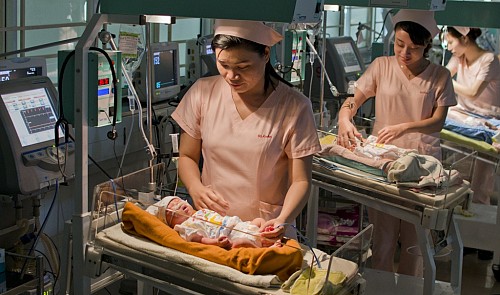 Nurses take care of babies. Huynh Nam Dong