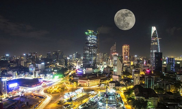 Supermoon over the sparkling Ho Chi Minh City, captured by Nguyen Dzung using double exposure technique on November 14, 2016.