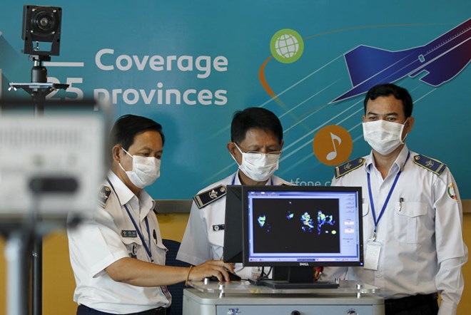 Officials from the Health Ministry’s communicable disease control department operate a thermal scanner at Phnom Penh International Airport in 2016 (Photo: Reuters)