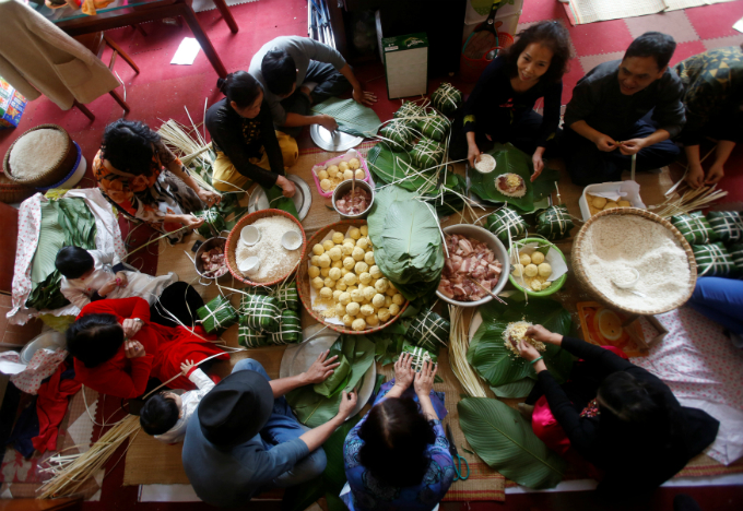 Residents gather to make the rice cake banh chung for Tet at a village in Hanoi in late January. Photo by Reuters/Kham