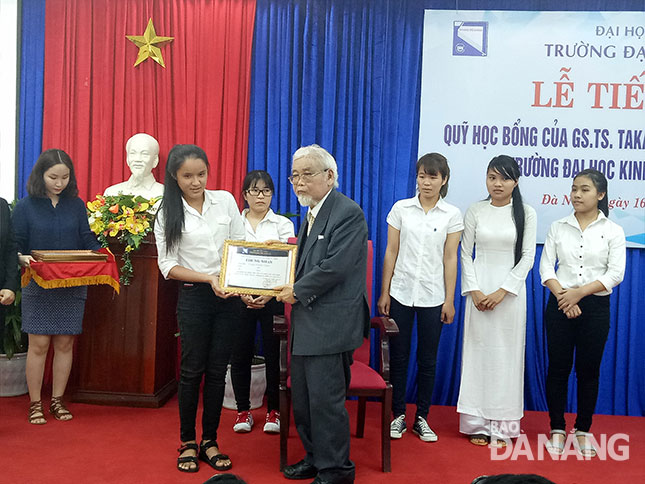 Professor Takahashi giving scholarships to some poor studious students at DUE 