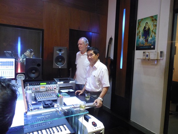 Thomas Ames and composer Kiều Tấn at a studio recording the song 