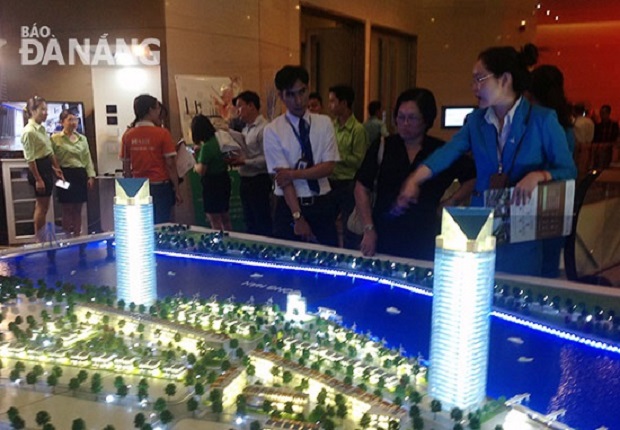 Visitors view a model of a real estate development