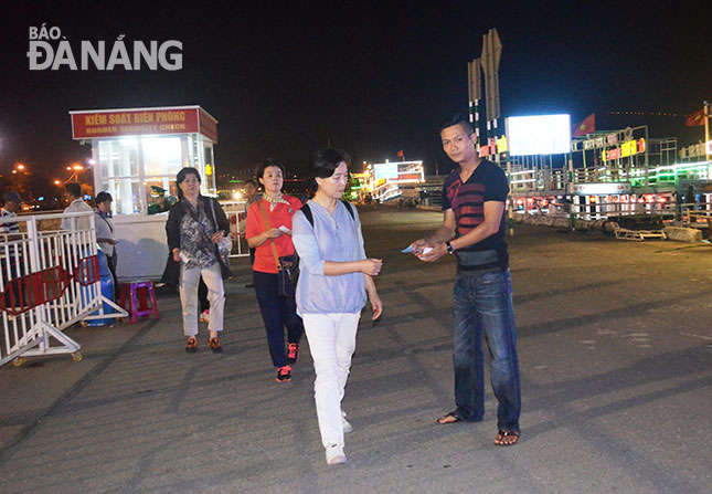 Passengers having their tickets checked before boarding 