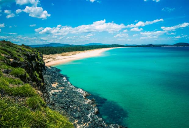 Phu Yen's trademark blue beaches and its rocky shores draw thousands of tourists during the summer. Photo by Quynh Trang