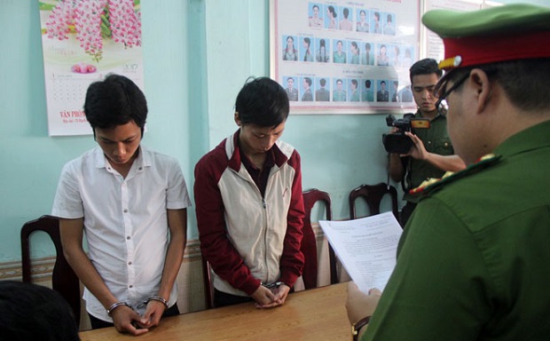 Linh (left) and Trung at the police station