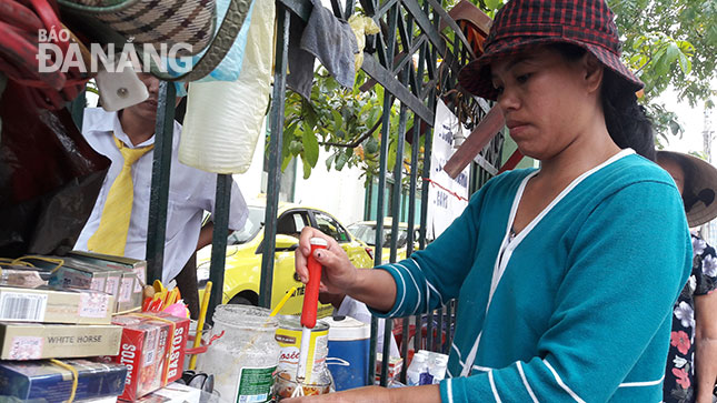 Chị Hồ Thị Hoàng Anh, bán cà-phê vỉa hè nuôi 4 con ăn học. 		              Ảnh: PHAN CHUNG
