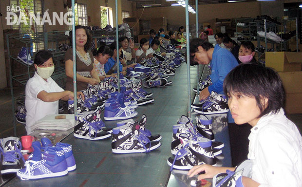 Workers at a local sports shoe company