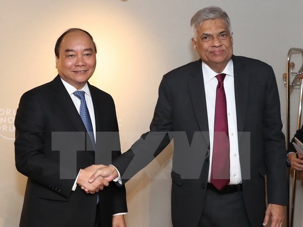 Prime Minister Nguyen Xuan Phuc (L) meets with Sri Lanka’s Prime Minister Ranil Wickremesinghe on the sideline of the World Economic Forum's 47th annual meeting in Davos in January 2017