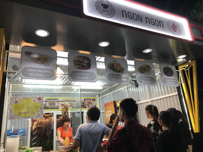 A food stall with a queue of hungry customers