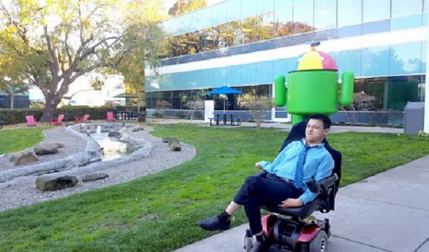 Tran Manh Chanh Quan poses in his wheelchair in front of Internet giant Google’s headquarters in California, the U.S. after sitting for their interview in November 2016. Courtesy of Truong Manh Thanh Thao