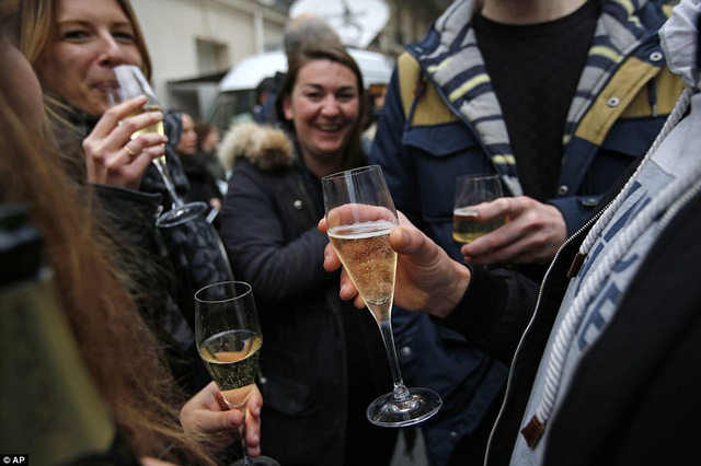 Người Pháp uống sâm-panh ăn mừng chiến thắng của ứng viên tổng thống Macron. (Ảnh: AP)