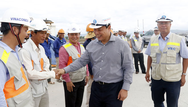 Chairman Viet (left) shaking hands with construction workers