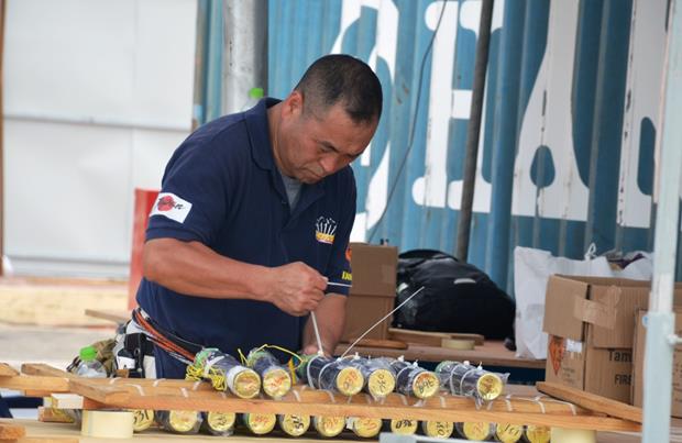 Another Japanese team member carefully preparing the fireworks