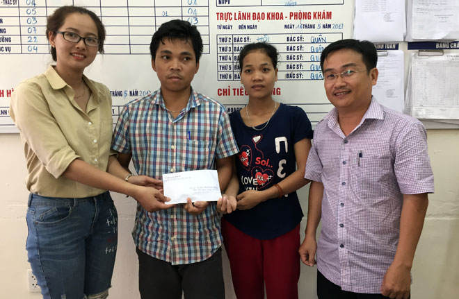 The Newspaper’s Deputy Editor-in-Chief, Hua Van Hai (1st right) and a representative from the company (1st left) handing the donation to Quan’s parents