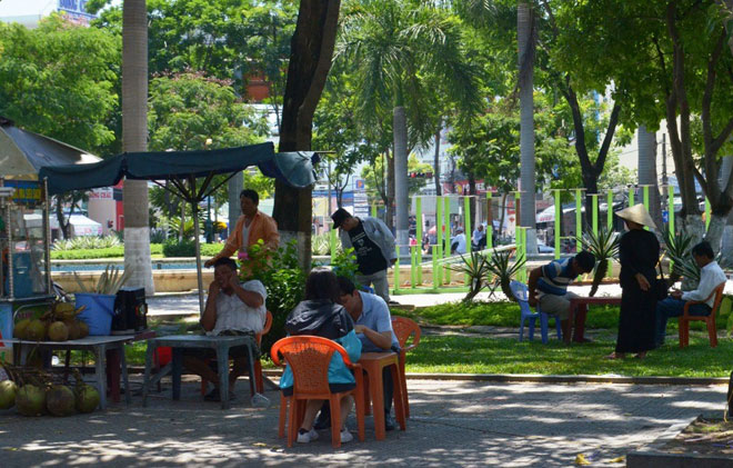 People sitting in the shade in a local park