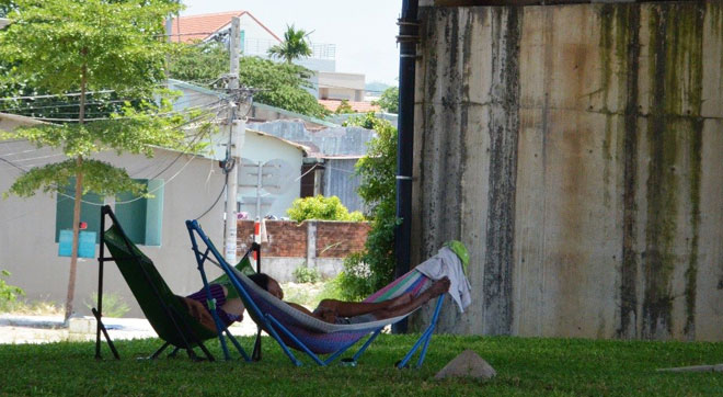 Families taking a rest under the Hue T-junction overpass