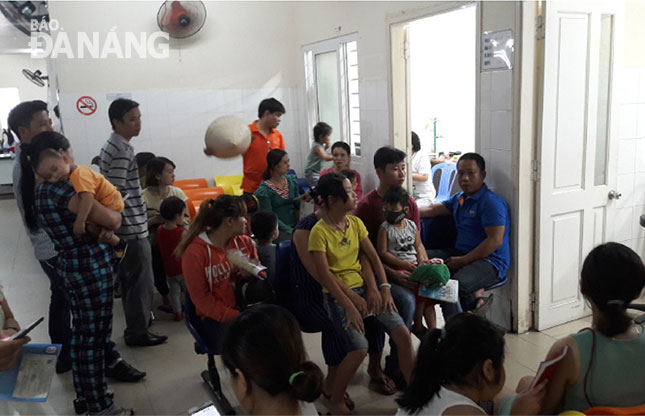 Parents with their children waiting for medical examinations at the Maternity and Paediatrics Hospital