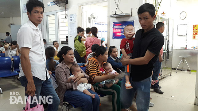 Parents with their children waiting for medical examinations at the Maternity and Paediatrics Hospital