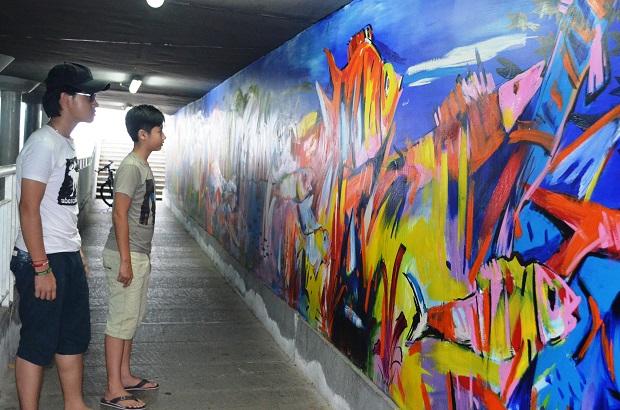 Visitors enjoying the acrylic beach paintings