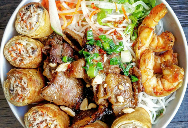 Bun thit nuong cha gio, a mixture of rice noodles, lean grilled pork, fried spring rolls and fresh vegetables.