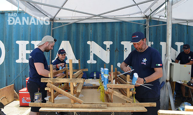 Photo: Italian team members preparing their fireworks in the extremely hot weather