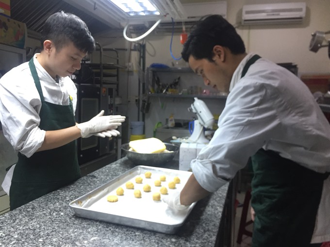 Hard at work: The young graduates in the kitchen, making their cricket cookies. Read more at http://vietnamnews.vn/life-style/379128/young-graduates-succeed-with-their-bug-idea.html#Qs2vY7a2UTpevVdU.99