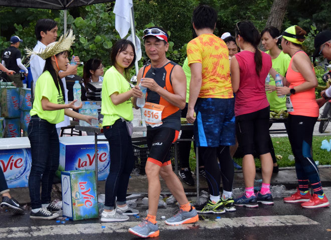 Local volunteers providing free water bottles to runners
