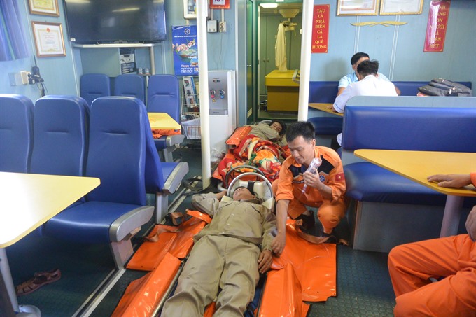 Two sick fishermen receive first aid on a rescue ship in the sea off Hoàng Sa (Paracels) Island of Việt Nam. — Photo courtesy of MRCC2 Read more at http://vietnamnews.vn/society/392271/sick-fishermen-rescued-off-hoang-sa-island.html#i7O4yxvQUqrfWc2f.99