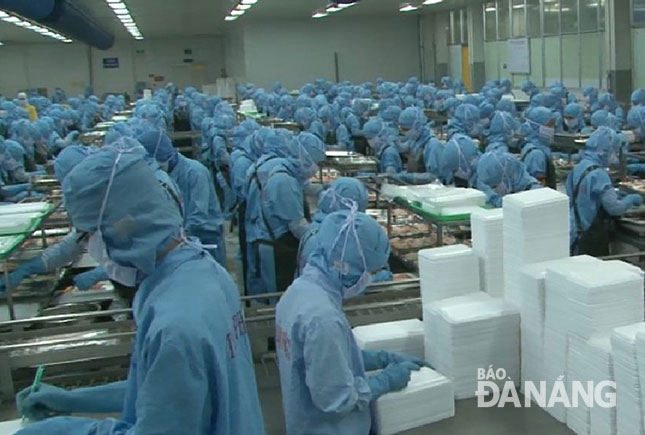 Workers at a local seafood processing company