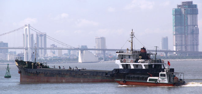 A small boat of terrorists approaching the international cargo ship