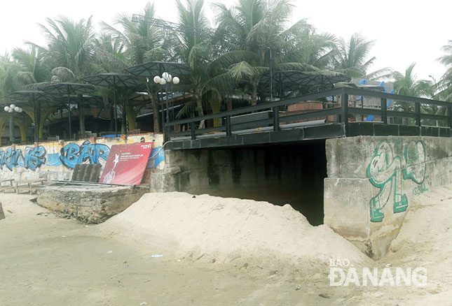 A sewage outlet is covered with sand