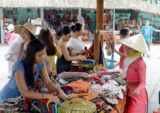 Visitors buying brocade items 