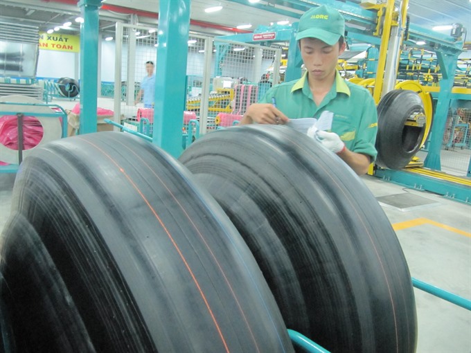 Quality check: A worker inspects the quality of rubber tyres at a factory in Đà Nẵng. — VNS Photo Công Thành Read more at http://vietnamnews.vn/economy/416535/apec-summit-a-golden-chance.html#M8ygqltaSD6Ibewi.99